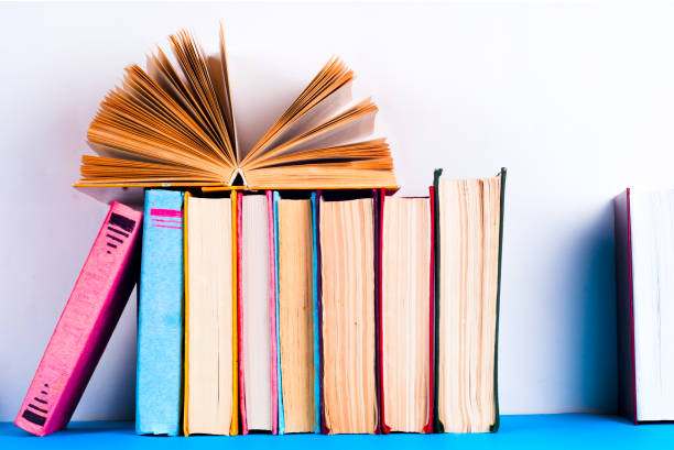 open book, hardback bookson bright colorful background. - brown paper imagens e fotografias de stock