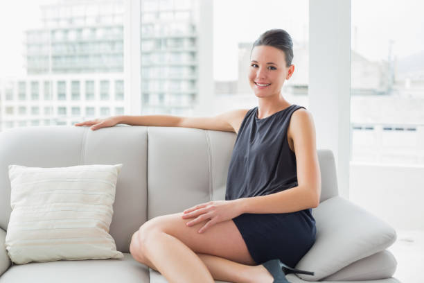 istock Smiling well dressed woman sitting on sofa at home 836227640
