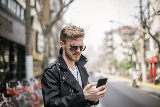istock Man using mobile phone on the street 836227824