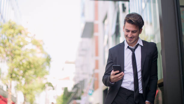 istock Smiling man texting outdoors 836233960