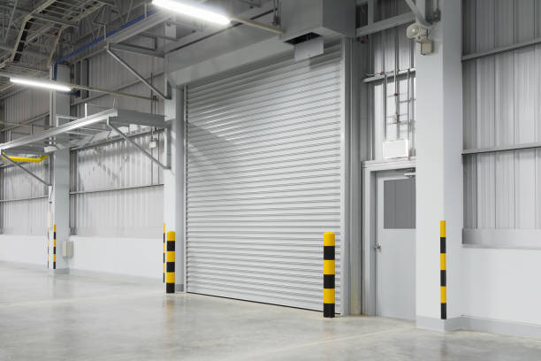 shutter door factory Roller shutter door and concrete floor outside factory building for industry background. shutter door stock pictures, royalty-free photos & images