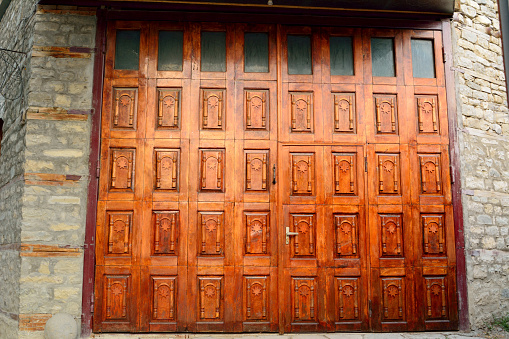 Lahic, Azerbaijan – August 11, 2017. Wooden multi-paneled door in Lahic village in Azerbaijan.