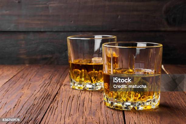 Whisky With Ice In Two Glasses On A Wooden Background Copy Space Food Background Stock Photo - Download Image Now