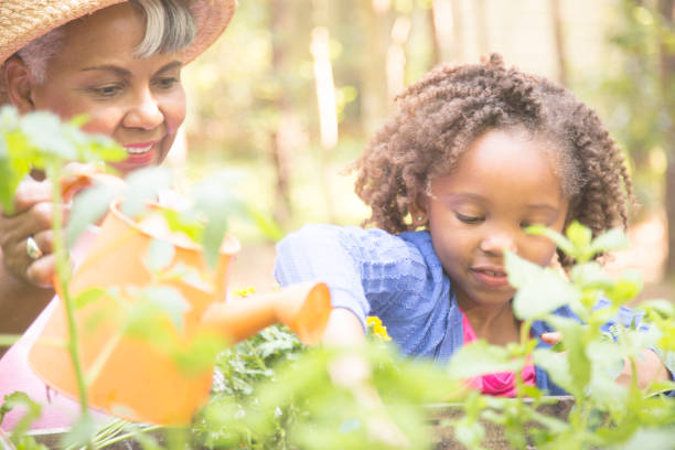 istock Grandmother and child gardening outdoors in spring. 836241940