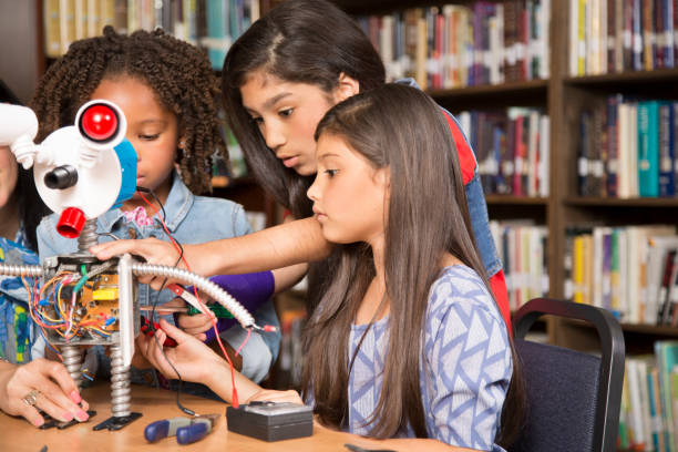 istock Elementary age school girls build robot in technology class. 836245110