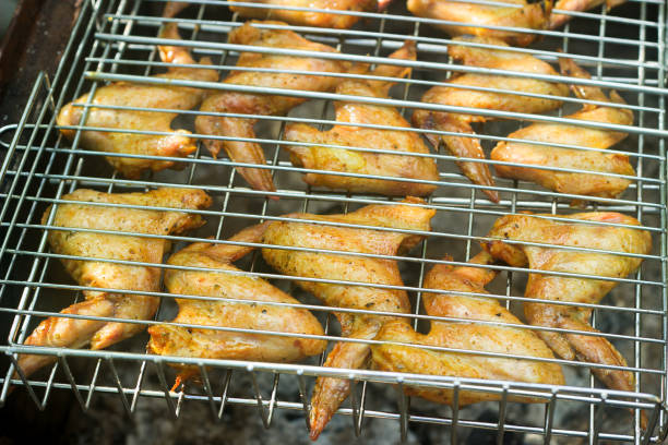 istock Chicken wings on barbecue grill with fire 836248476