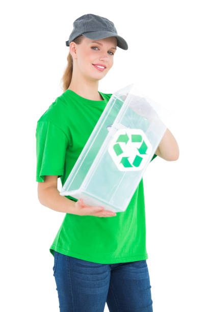 istock Cheerful pretty environmental activist holding a recycling box 836248636