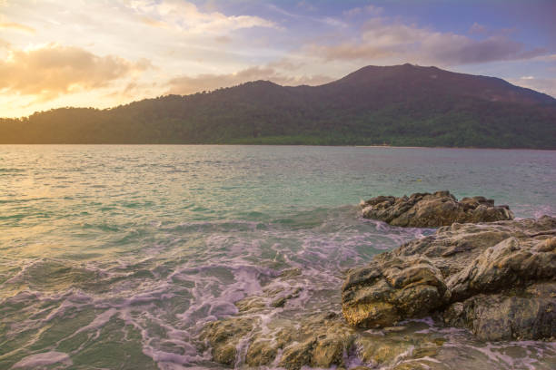 istock Splash waves hit rocks with the beautiful sunlight and sky . 836249246