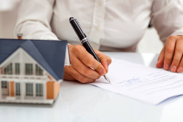 A mortgage broker signing a paper