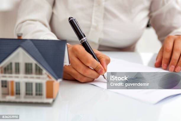 Purchase Agreement For Hours With Model Home Stock Photo - Download Image Now - House, Real Estate, Insurance