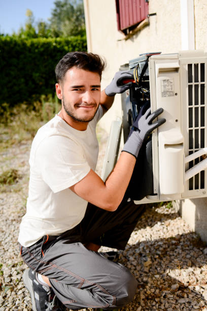 istock young man electrician installer working on outdoor compressor unit air conditioner at a client's home 836252434