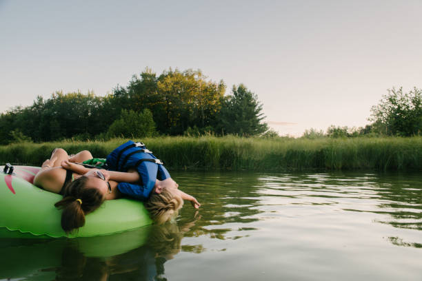 Tubing in river Young people floating down river in inner tubes Michigan stock pictures, royalty-free photos & images