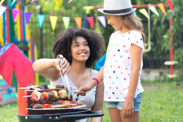 istock Mother and daughter preparing tasty barbecue on back yard 836258534