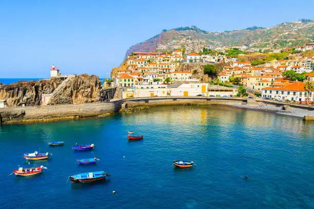 Photo of View of Camara de Lobos port with colourful fishing boats on sea, Madeira island