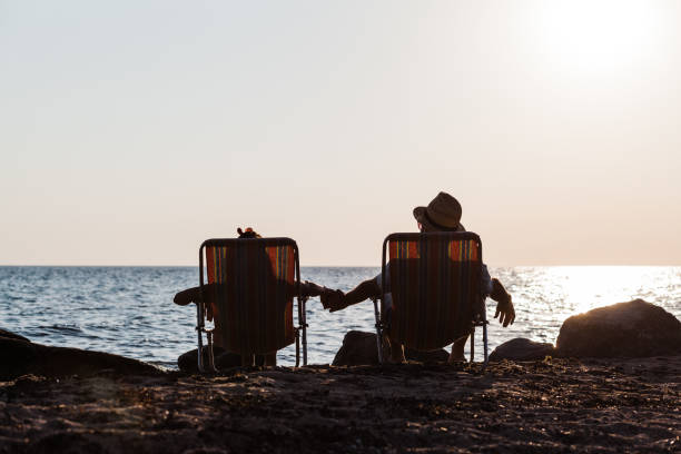 istock Couple enjoying sunset at a beach 836262752