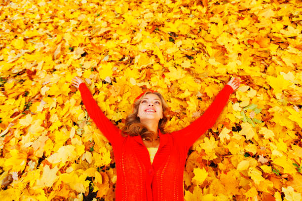 istock Woman laying on autumn leaves 836265336