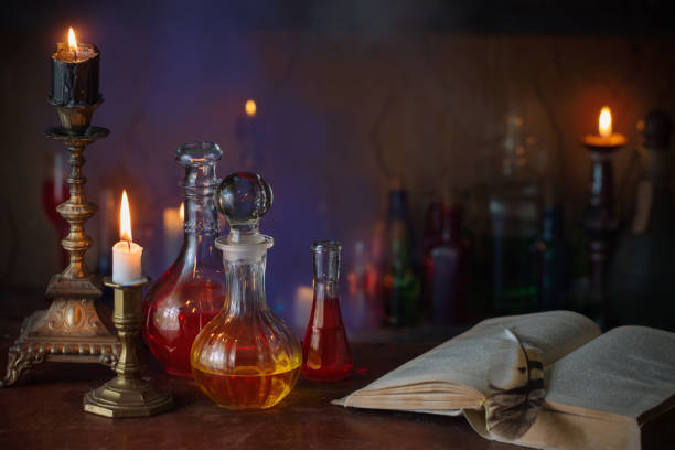 istock Magic potion, ancient books and candles on dark background 836269824