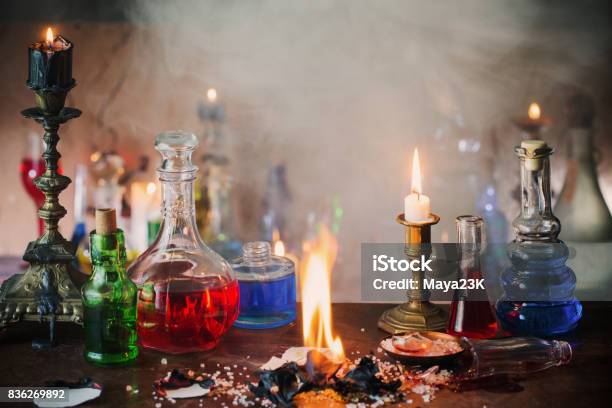 Magic Potion Ancient Books And Candles On Dark Background Stock Photo - Download Image Now