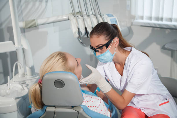 istock Female dentist examining 836277138