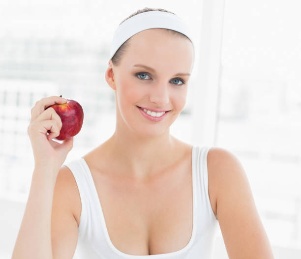 istock Smiling pretty sportswoman holding an apple 836277148