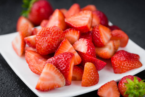 istock Portion of Chopped Strawberries on a slate slab 836280490