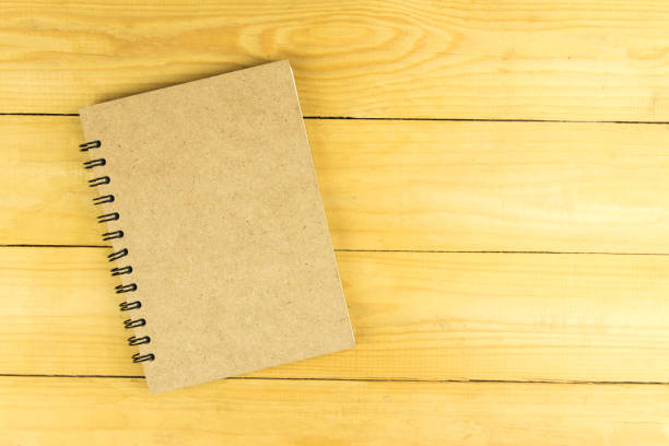 istock Blank book of brown on wooden table. top view 836286902