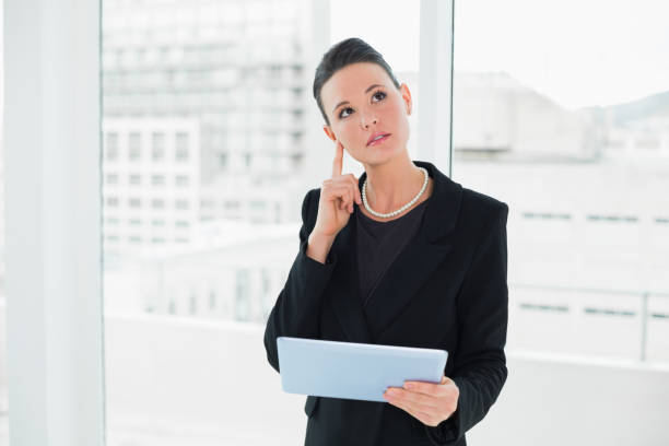 istock Thoughtful elegant businesswoman holding tablet PC 836287408