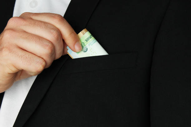 istock A man putting South African money into his pocket. This image has selective focusing. 836287922