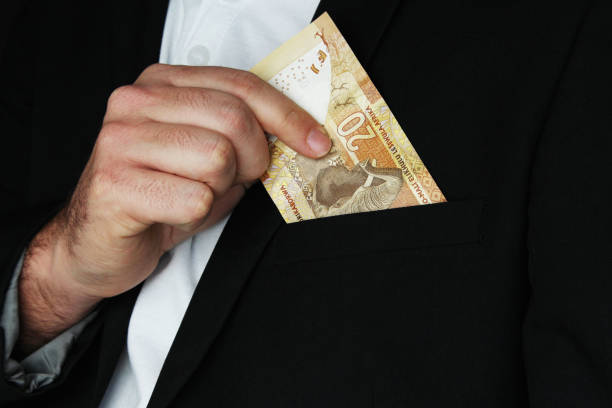 istock A man putting South African money into his pocket. This image has selective focusing. 836288754