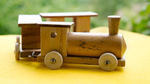 istock wooden toy train on yellow table 836291790