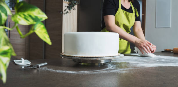 istock Woman preparing fondant for cake decorating, focus on cake 836292156