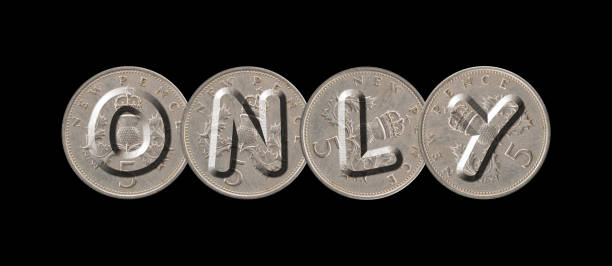 ONLY – Five new pence coins on black background