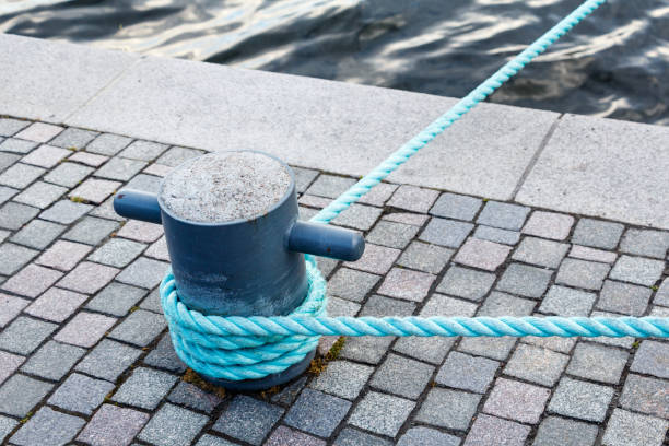 istock Mooring rope with a knotted end tied around a cleat on a pier 836295746