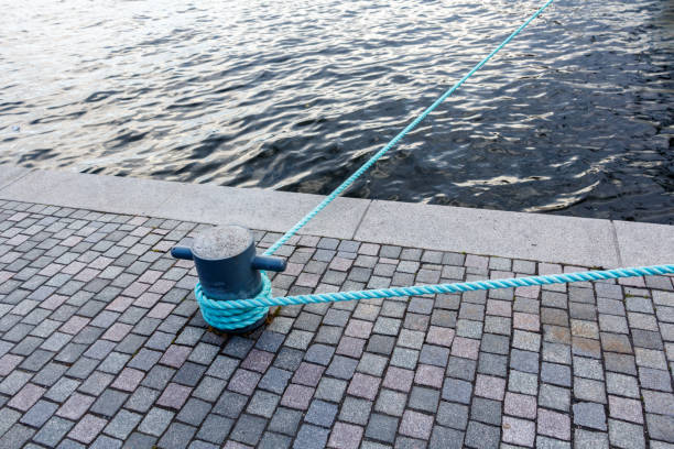 Mooring rope with a knotted end tied around a cleat on a pier
