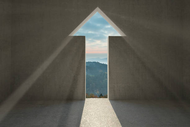 Arrow door in dark room with light shining in