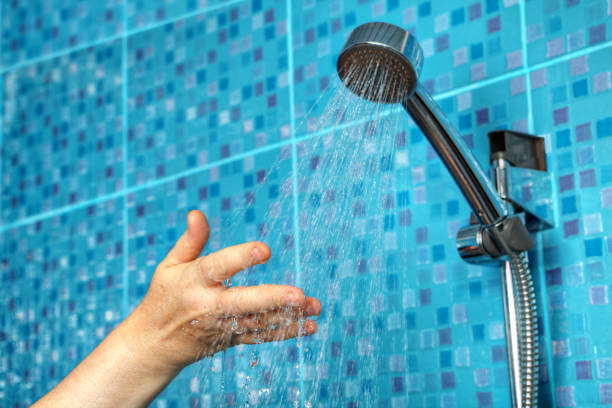 istock Hand under streams of water from the shower head. 836300420