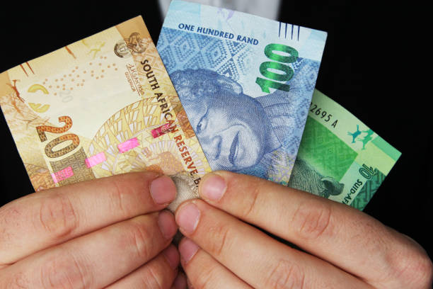 istock A man holding South African money. This image has selective focusing. 836312574