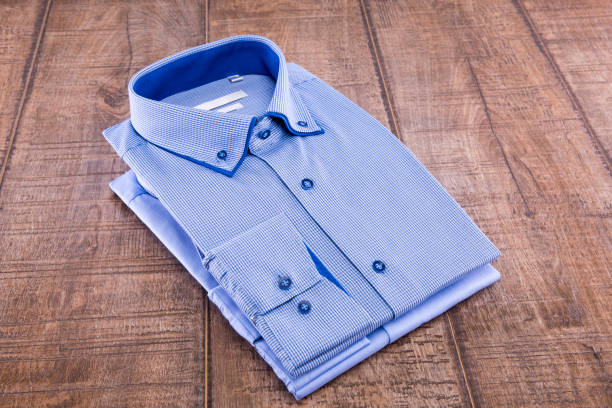 istock Two men's shirts folded on a wooden background 836329138