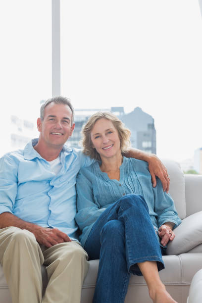 istock Cheerful couple relaxing on their couch 836346796