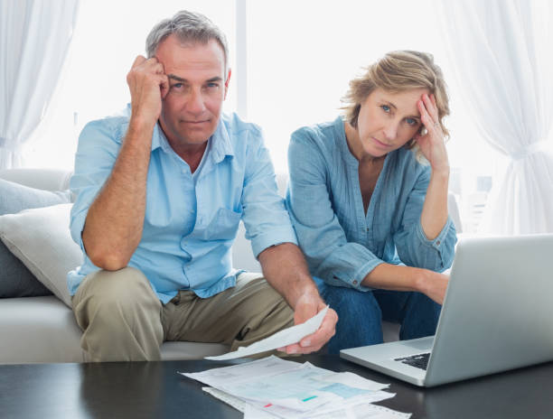 istock Anxious couple paying their bills online with laptop 836347126