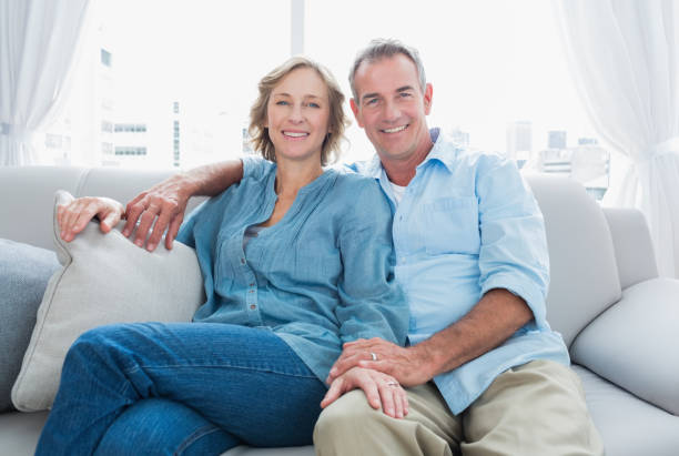 istock Middle aged couple relaxing on the couch 836347452
