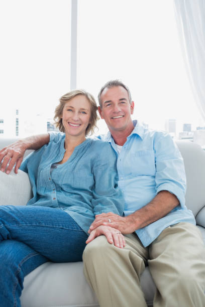 istock Middle aged couple sitting on the couch 836347492