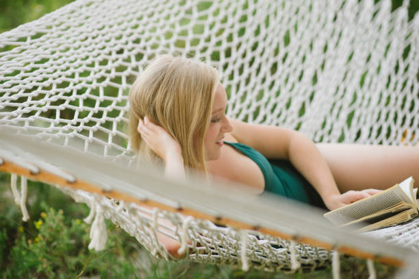 istock Young woman laying in hammock 836350524