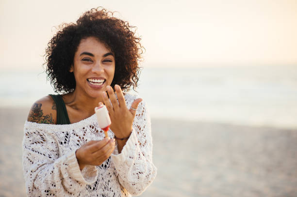istock Woman eating popsicle at beach 836350610