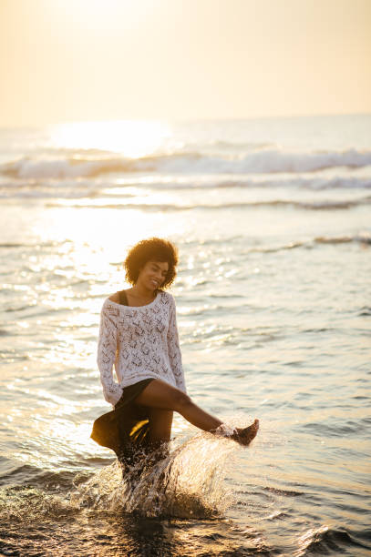 istock Black woman having fun at beach 836350648