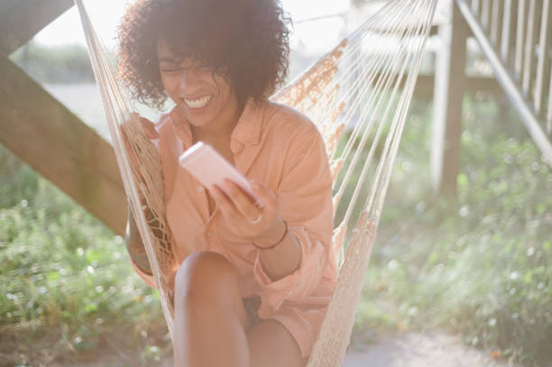 istock Laughing woman on hammock 836350686