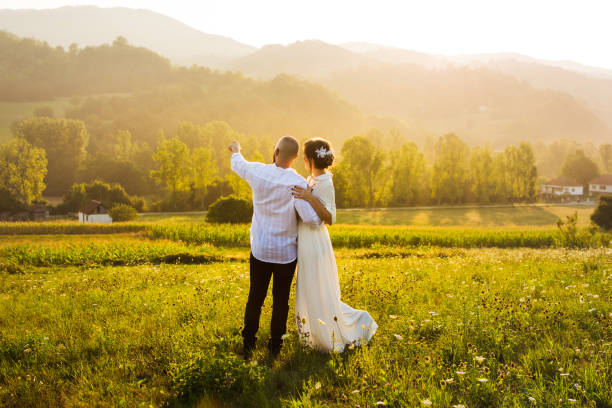 istock Couple enjoying sunset view in the field 836357830