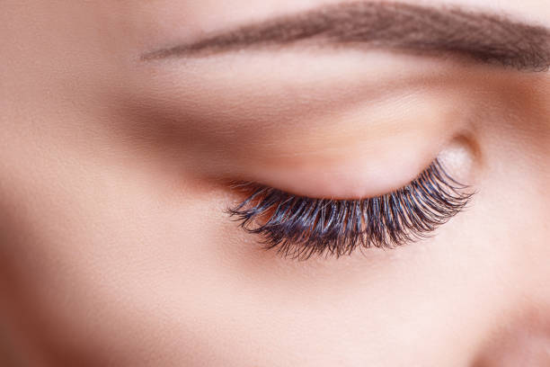 Eyelash Extension Procedure. Woman Eye with Long Eyelashes. Lashes, close up, macro, selective focus