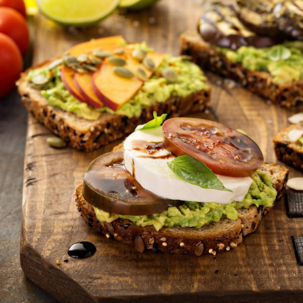 istock Variety of avocado toasts on a cutting board 836365444
