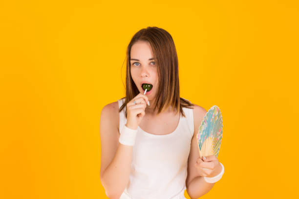 istock Young pretty woman with fan, studio 836368408